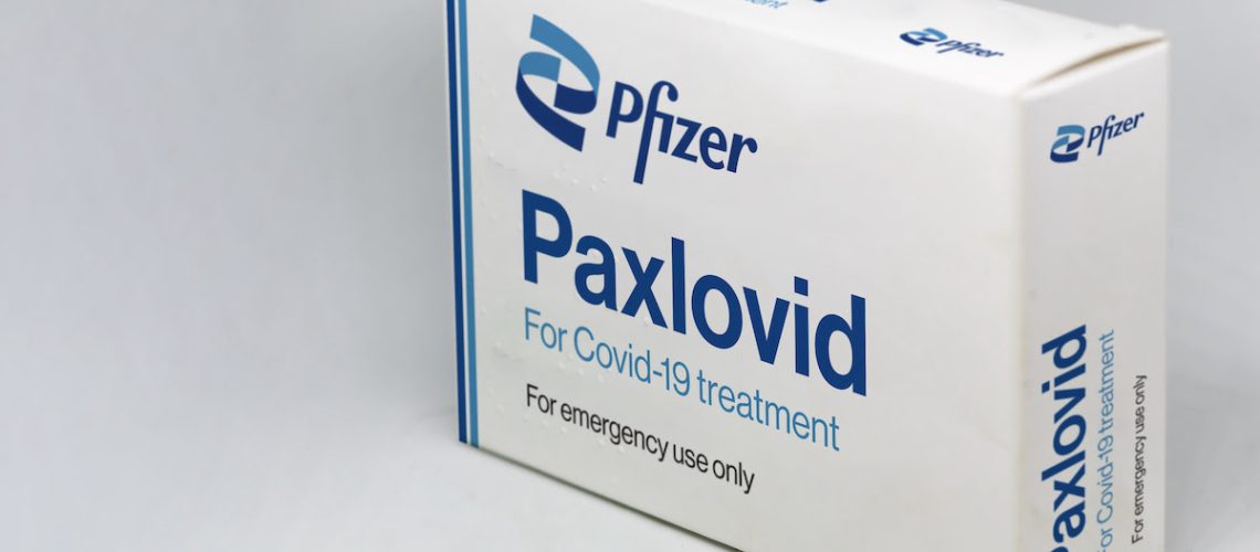 New York, USA, November 2021: Pfizer Covid-19 Paxlovid treatment box isolated on a white background. Health and prevention.