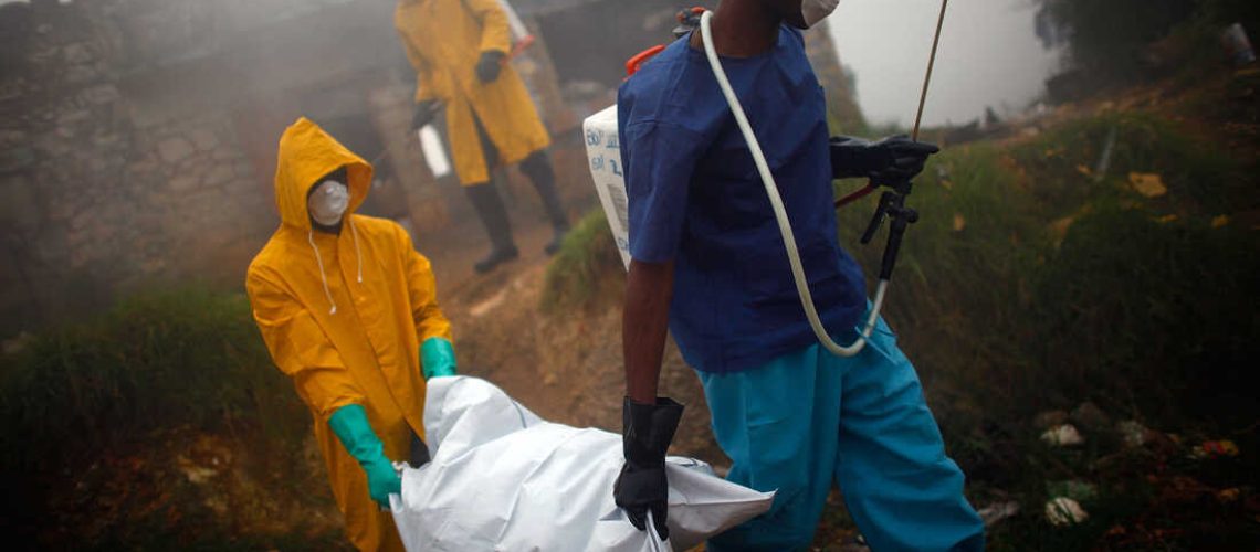 Health workers collect the body of a cholera victim in Petionville, Haiti, in February 2011. The disease first appeared on the island in October 2010, likely introduced by U.N. peacekeepers from Nepal, possibly a single individual.